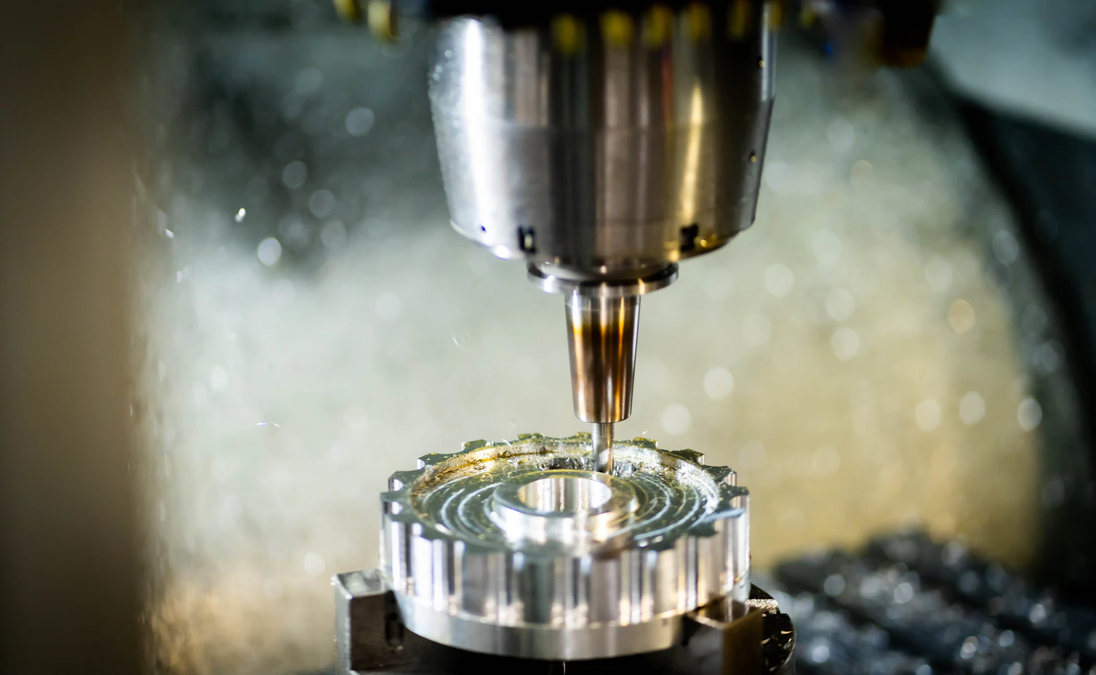 CNC mill spindle machining a round aluminum part
