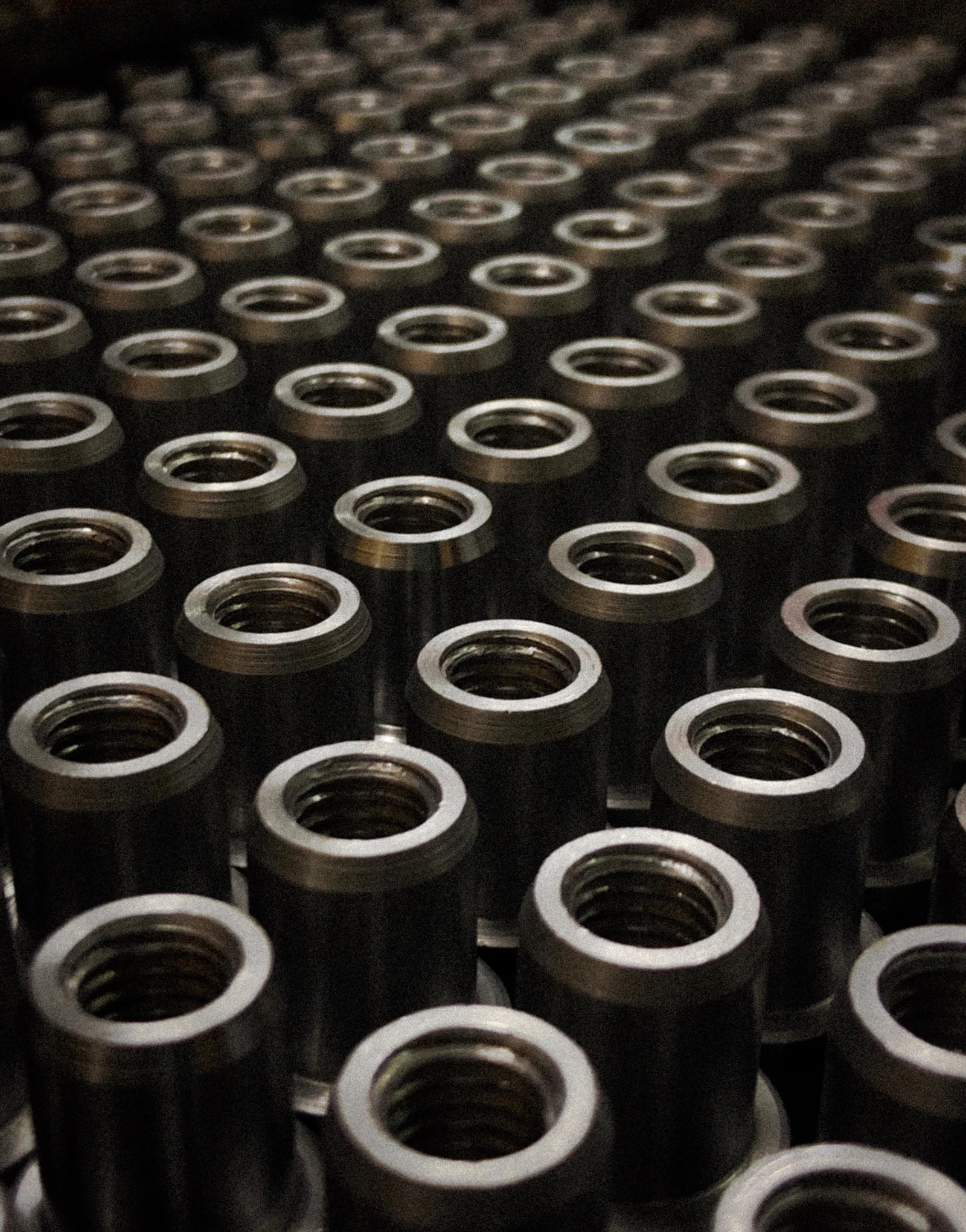 Rows of machined metal flanges from a low-volume production run